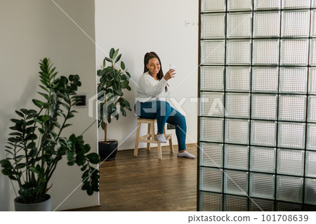 African american woman making video call in living room - social networks and connection African american woman making video call in living room - social networks and connection 101708639