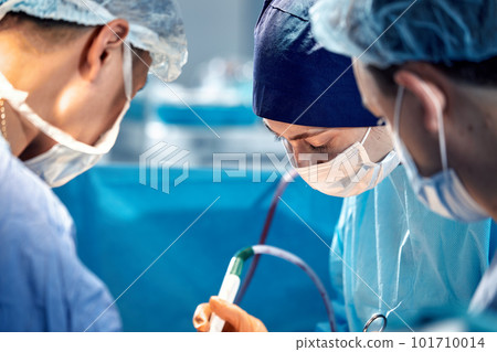 International team of surgeons in the operating room during the operation. Modern medicine, international medical workers during a complex operation, modern medicine. 101710014
