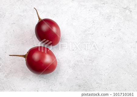 Closeup Fresh Tamarillo Fruit On Table. Egg-shaped Edible Fruit Known As Tree Tomato, Plant Family Solanaceae, Solanum Betaceum. Top View. Flat Lay. Copy Space For Text. Horizontal Plane 101710161