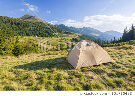 Tourist tent in mountains on a summer sunny day 101710458