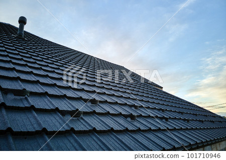 Snow guard for safety in winter on house roof top covered with ceramic shingles. Tiled covering of building Snow guard for safety in winter on house roof top covered with ceramic shingles. Tiled covering of building 101710946