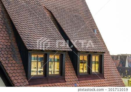 Roof attic windows in old tiled european house 101711019