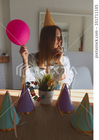 Portrait of young girl in casual clothes getting ready to celebrate birthday. Woman standing at home on daytime with sunlight Portrait of young girl in casual clothes getting ready to celebrate birthday. Woman standing at home on daytime with sunlight 101711185