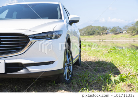 Blue riverbed and white SUV car 101711332
