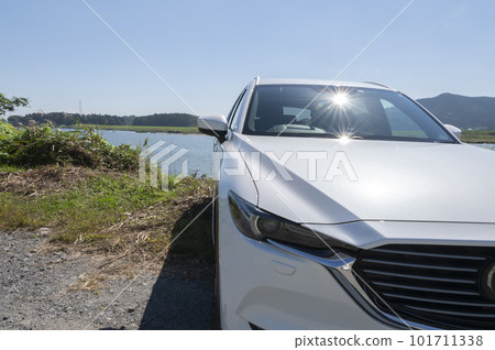Blue riverbed and white SUV car 101711338