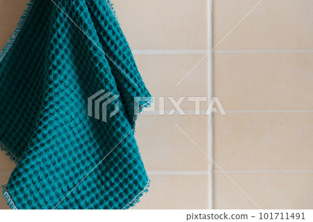Kitchen blue waffle towel hanging on the wall 101711491