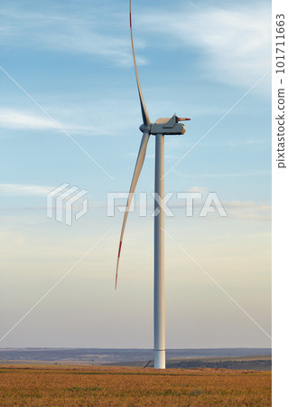 Wind energy. Wind power. Sustainable, renewable energy. Wind turbines generate electricity. Windmill farm on mountain with sunset sky. Green technology. Renewable resource. Sustainable development. Wind energy. Wind power. Sustainable, renewable energy. Wind turbines generate electricity. Windmill farm on mountain with sunset sky. Green technology. Renewable resource. Sustainable development. 101711663