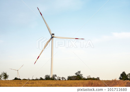 Wind energy. Wind power. Sustainable, renewable energy. Wind turbines generate electricity. Windmill farm on mountain with sunset sky. Green technology. Renewable resource. Sustainable development. 101711680