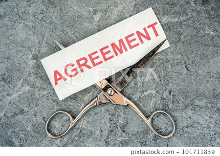 Metal scissors cutting paper with a written word AGREEMENT Metal scissors cutting paper with a written word AGREEMENT 101711839