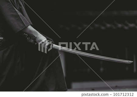 A person holding a Japanese sword A person holding a Japanese sword 101712312