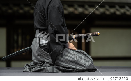A person holding a Japanese sword A person holding a Japanese sword 101712320