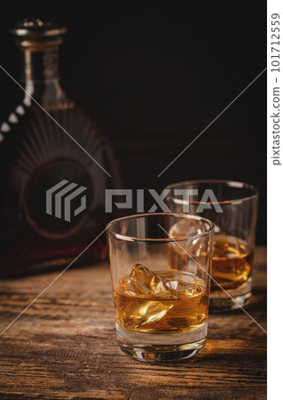 Whiskey with ice in glasses Whiskey with ice in glasses 101712559