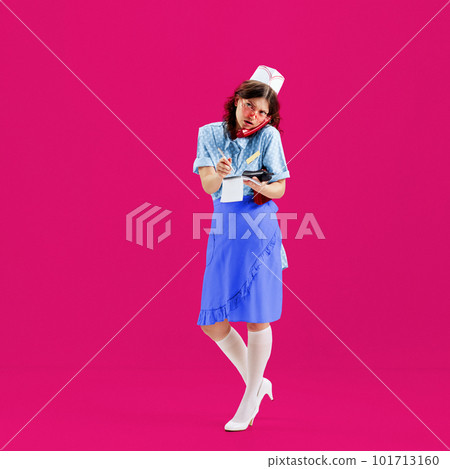 Beautiful young girl in image of retro cater waiter wearing 70s, 80s fashion style uniform isolated over bright pink background. Trash pop art. Charm, ad, sales, fashion, emotions 101713160