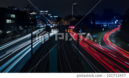 Long exposure - light traces of cars on the A40 freeway in Essen, Germany. German Autobahn at night 101713457