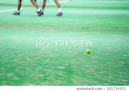 A tennis ball rolled over the edge of the court during a tennis match 101714331