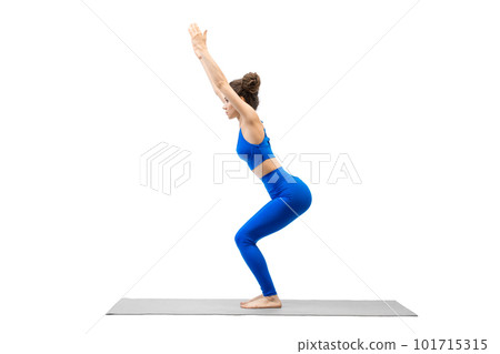 Caucasian young woman in blue sportswear practice chair pose, Utkatasana, isolated on white. Caucasian young woman in blue sportswear practice chair pose, Utkatasana, isolated on white. 101715315