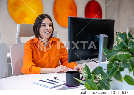 Focused employee working on the desktop PC in the office Focused employee working on the desktop PC in the office 101716323