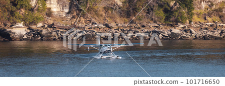 Seaplane in Water ready for Take off with Rocky Shore in Background. 101716650
