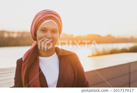 Young Arabic muslim woman in hijab walking at street seafront copy space and place for advertising 101717017