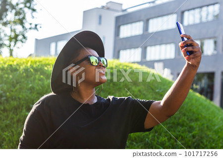 Attractive African woman taking selfie on the street wearing glasses - millennial and generation z concept Attractive African woman taking selfie on the street wearing glasses - millennial and generation z concept 101717256