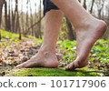 Lifestyle barefoot walk on grass in forest 101717906