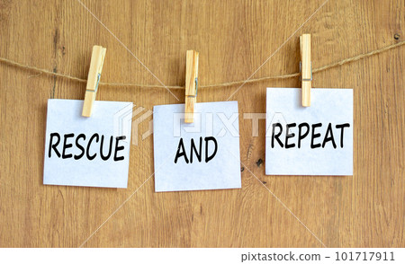 Rescue and repeat symbol. Concept words Rescue and repeat on white paper on wooden clothespin on a beautiful wooden table wooden background. Business rescue and repeat concept. Copy space. Rescue and repeat symbol. Concept words Rescue and repeat on white paper on wooden clothespin on a beautiful wooden table wooden background. Business rescue and repeat concept. Copy space. 101717911