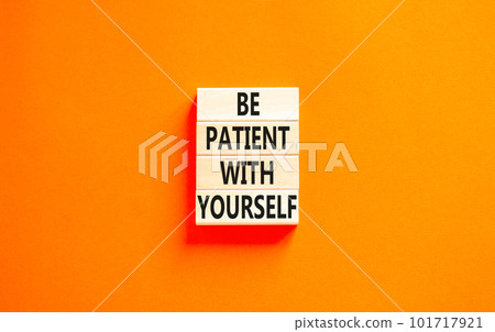Patient with yourself symbol. Concept words Be patient with yourself on wooden blocks. Beautiful orange table orange background. Business patient with yourself concept. Copy space. 101717921