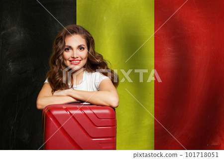 Welcome to Belgium. Happy woman with red suitcase on Belgian flag background. Travel, work 101718051