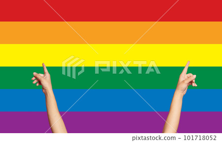 Female hands up on LGBT flag background 101718052