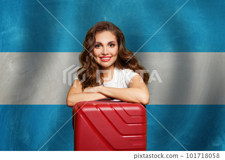 Welcome to Argentina. Perfect woman with red suitcase on Argentinean flag background.  101718058