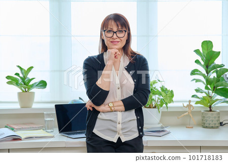 Portrait of confident mature woman in front of home office Portrait of confident mature woman in front of home office 101718183