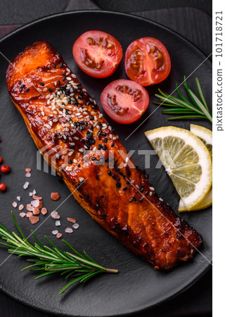 Delicious grilled red salmon fish with sauce, sesame seeds, spices and herbs 101718721