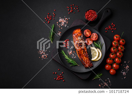 Delicious grilled red salmon fish with sauce, sesame seeds, spices and herbs 101718724