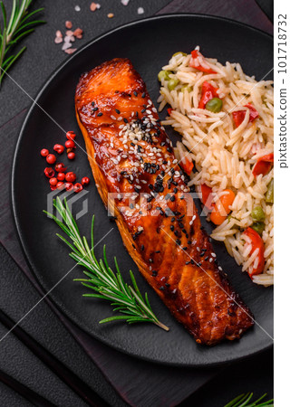 Delicious red salmon fish grilled with sauce and sesame seeds with rice and vegetables Delicious red salmon fish grilled with sauce and sesame seeds with rice and vegetables 101718732