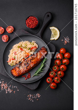 Delicious red salmon fish grilled with sauce and sesame seeds with rice and vegetables Delicious red salmon fish grilled with sauce and sesame seeds with rice and vegetables 101718745