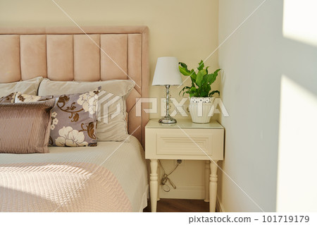 Classic bedroom interior in light ivory colors, in warm sunlight Classic bedroom interior in light ivory colors, in warm sunlight 101719179