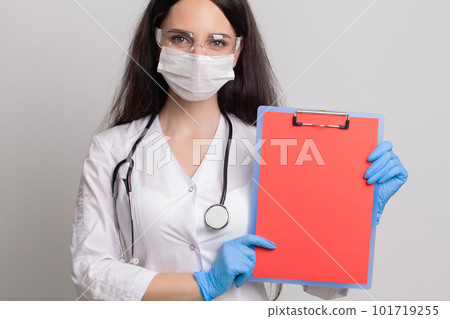 Female doctor holding a blank sheet of paper with space for text Female doctor holding a blank sheet of paper with space for text 101719255