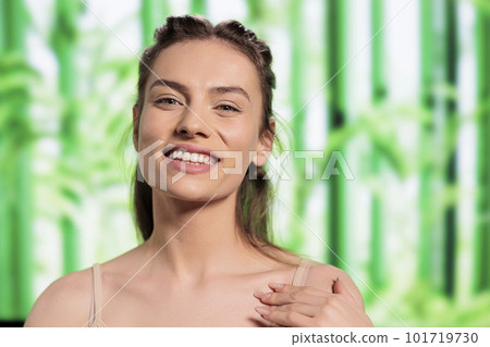 Happy smiling woman touching fresh body skin portrait. Attractive beauty model feeling good, looking at camera with positive facial expression showing bodycare and self love concept Happy smiling woman touching fresh body skin portrait. Attractive beauty model feeling good, looking at camera with positive facial expression showing bodycare and self love concept 101719730
