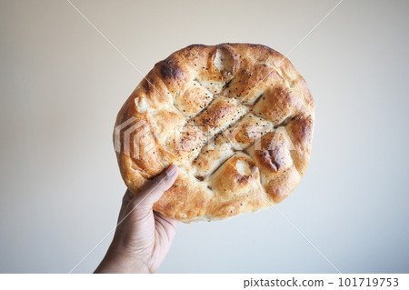 POV shot of holding a Ramadan Pide, Turkish popular bread, 101719753