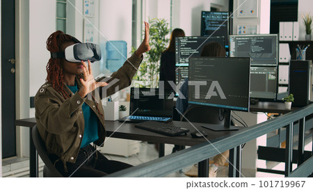 African american programmer working with vr glasses in it development office, using virtual reality headset to develop security program. Big data admin coding html script with database. 101719967