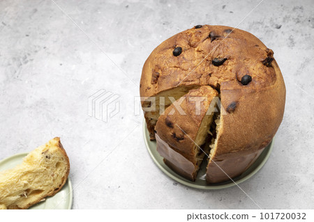 Top View Panettone Italian Sweet Cake On Table And Cut Piece. Sweet bread, Fruitcake Originally From Italy, Milan Baked Dessert. Copy Space For Text. Horizontal plane. Top View Panettone Italian Sweet Cake On Table And Cut Piece. Sweet bread, Fruitcake Originally From Italy, Milan Baked Dessert. Copy Space For Text. Horizontal plane. 101720032