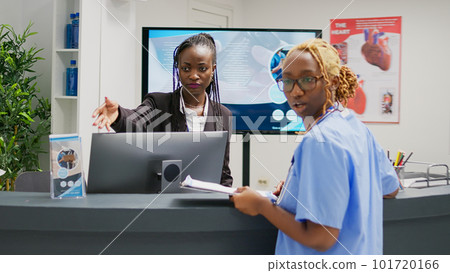Medical specialists working in health center with patients, helping people with treatment to cure disease diagnosis. Nurse consulting young man sitting in waiting room lobby, medication center. 101720166