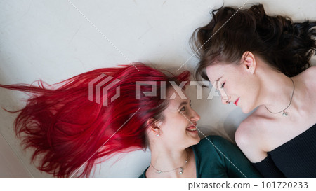 Top view of two women lying side by side. Lesbian intimacy. 101720233
