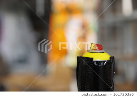 Vandalism spray paint bottles used for graffiti artwork on deserted building walls, empty neglected destroyed warehouse in ruins. Abandoned urban ghetto filled with garbage and wreck. Close up. 101720386