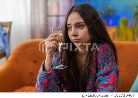 Sad depressed young woman girl suffers from unrequited love, drinking champagne, problem, bad news 101720467