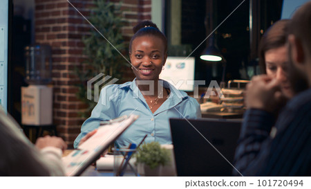 African american businesswoman smiling portrait in business meeting, coworkers talking in boardroom, slow motion. Diverse colleagues, woman looking at camera, slow motion medium shot. Handheld shot. African american businesswoman smiling portrait in business meeting, coworkers talking in boardroom, slow motion. Diverse colleagues, woman looking at camera, slow motion medium shot. Handheld shot. 101720494