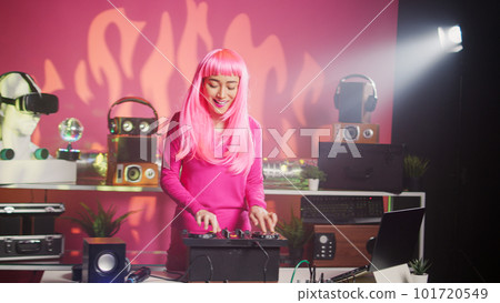 Smiling dj playing electronic sound using mixer console, creating unique remix for fans during techno party in nightclub. Musician enjoying performing music using professional audio equipment Smiling dj playing electronic sound using mixer console, creating unique remix for fans during techno party in nightclub. Musician enjoying performing music using professional audio equipment 101720549