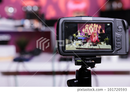 Content creator recording podcast talking with subscribers discussing lifestyle advice filming vlog in creative studio. Asian influencer live streaming using professional vlogging equipment 101720593