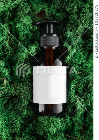 Amber dark glass bottle with dispenser of cosmetic product on green moss background, mock up. Organic body treatment, skin care, spa concept. Biophilia design. Vegan eco bio friendly cosmetology. Amber dark glass bottle with dispenser of cosmetic product on green moss background, mock up. Organic body treatment, skin care, spa concept. Biophilia design. Vegan eco bio friendly cosmetology. 101720875