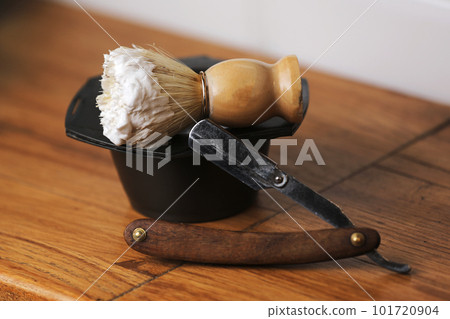 Set of shaving equipment and men's cosmetic products on wooden table, barbershop. shave concept with a straight razor, shaving brush and foam. 101720904